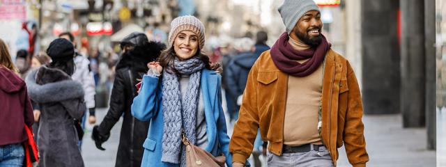 Shoppers with packages on busy street