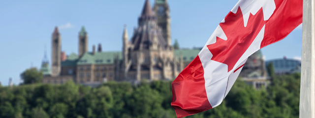 Canadaian flad with the Parliament buildings in the background