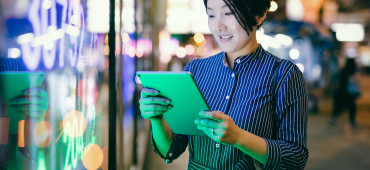 Woman outside looking at account