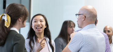 Group of Payments Canada employees talking with more poeple in the background