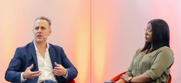 Philip Straley and Omotola Adogba on stage at The 2025 SUMMIT