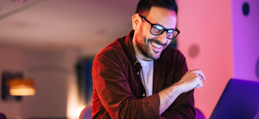 Person at home smiling at computer