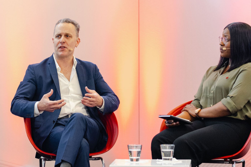 Philip Straley and Omotola Adogba on stage at The 2025 SUMMIT